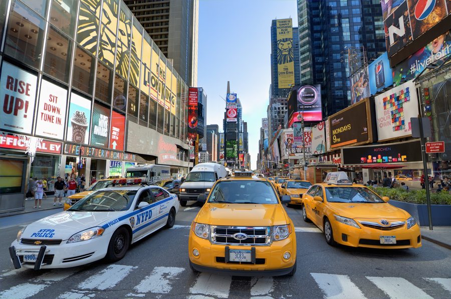Times Square with yellow cabs and billboards